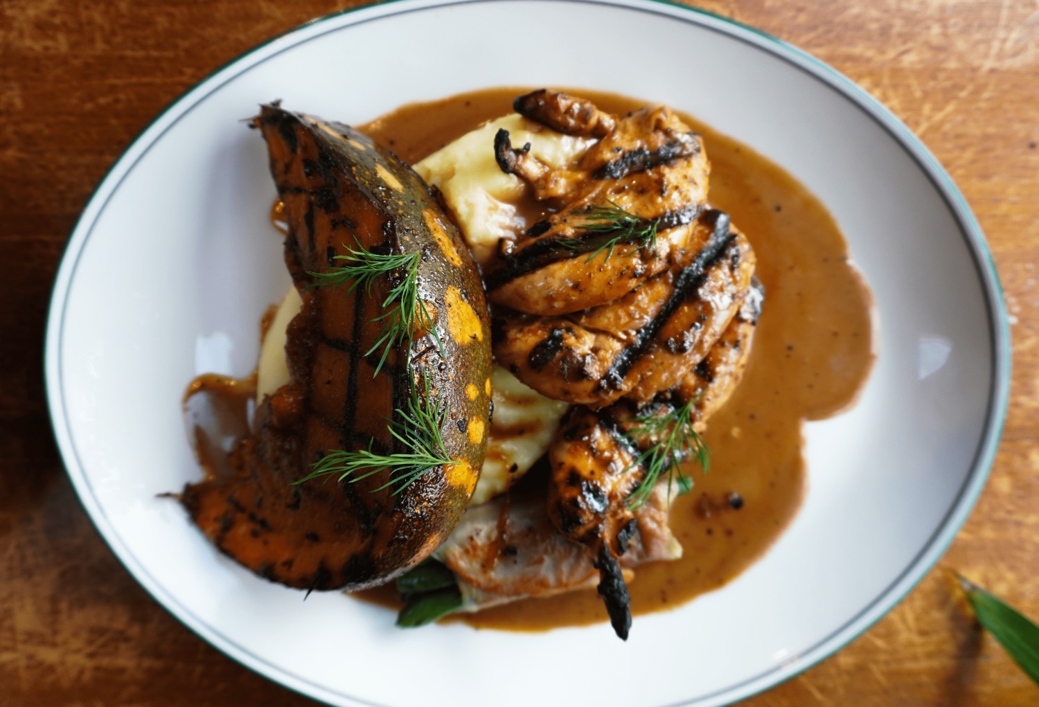 Char-grilled chicken with roast pumpkin and mash, finished with pepper sauce
