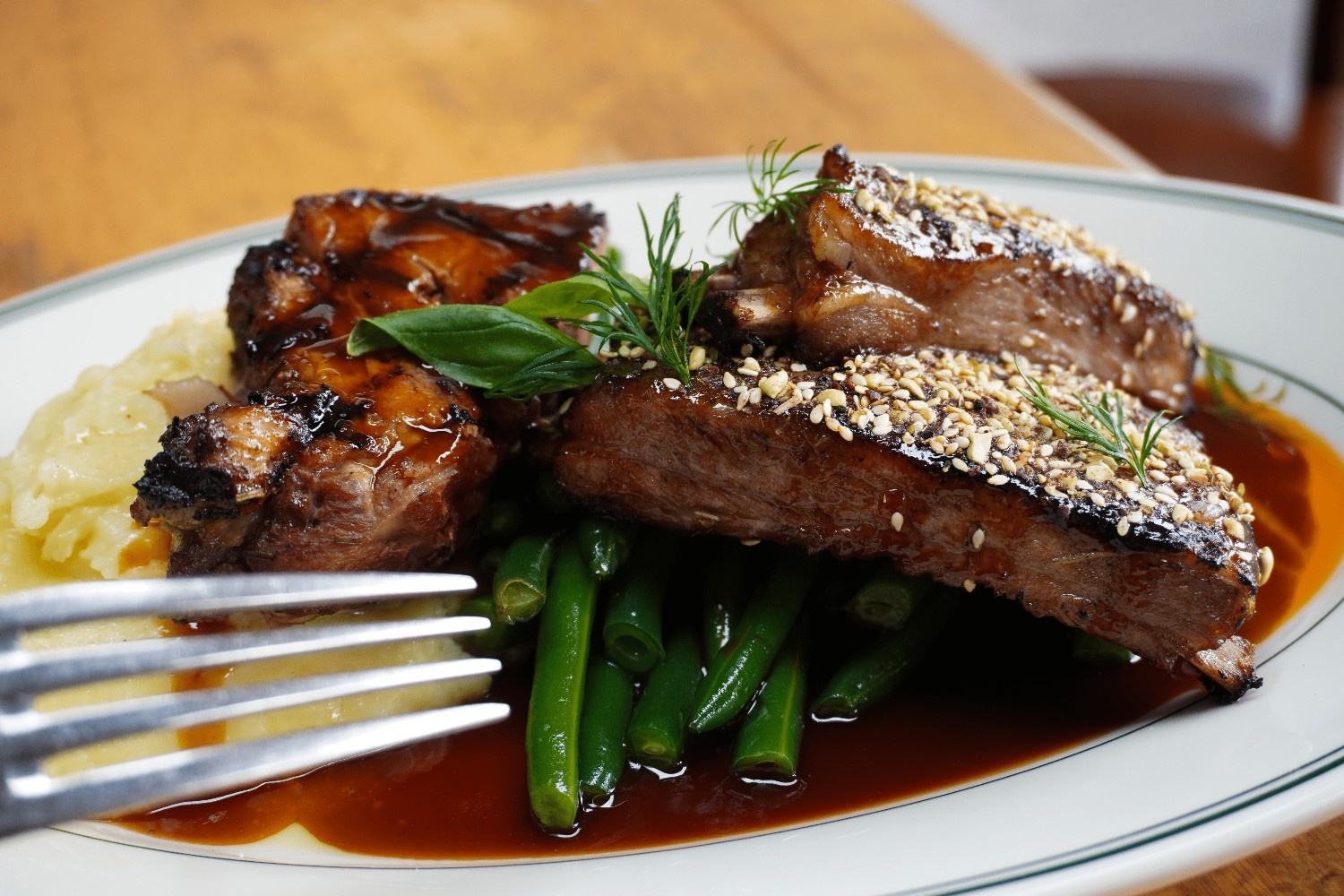 Slow-cooked ribs with sesame crust, green beans and rich glaze